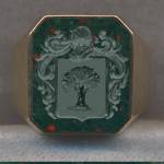 Ring #9, a 14k gold and Bloodstone signet ring engraved with a Family Crest or Coat of Arms.